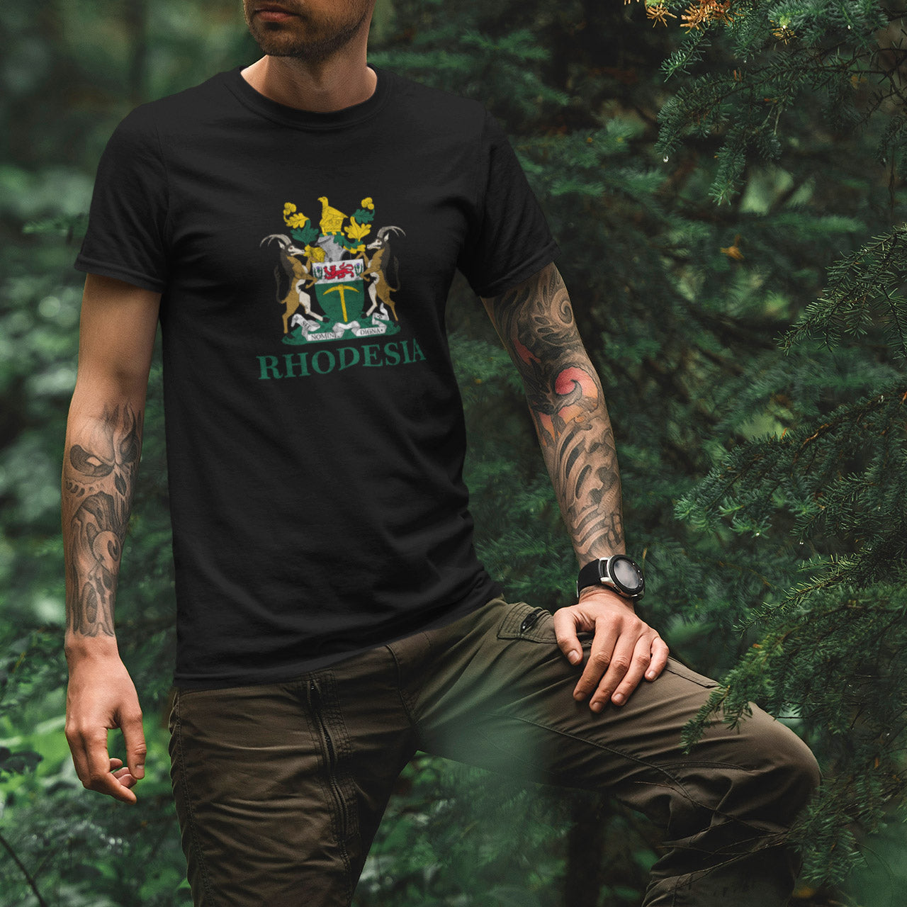 A person wearing a black crew neck t-shirt with the Rhodesia Coat of Arms printed on the front.